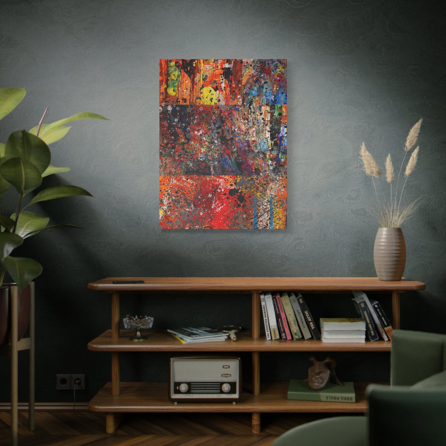 Abstract painting on a wall above a wooden shelf with books and decor.