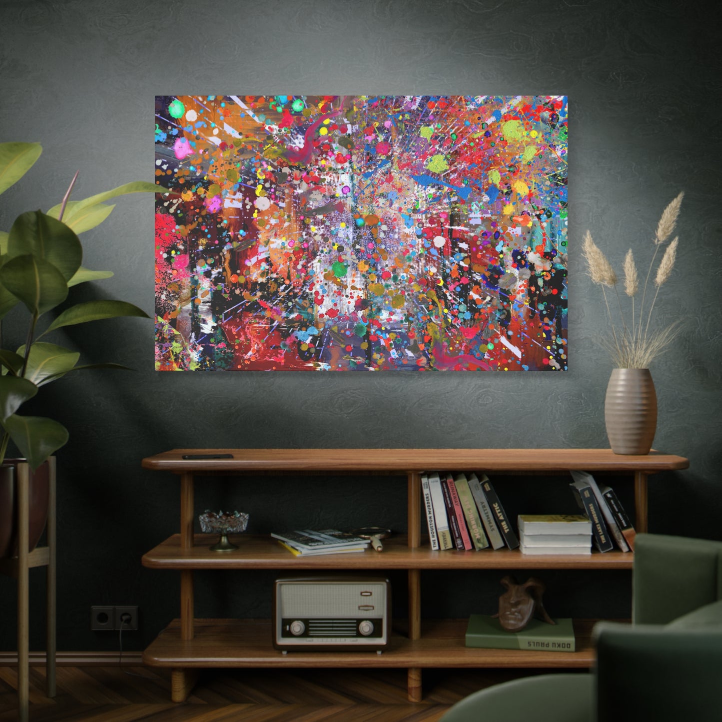 Colorful abstract painting on a dark wall above a wooden shelf with books and decor.