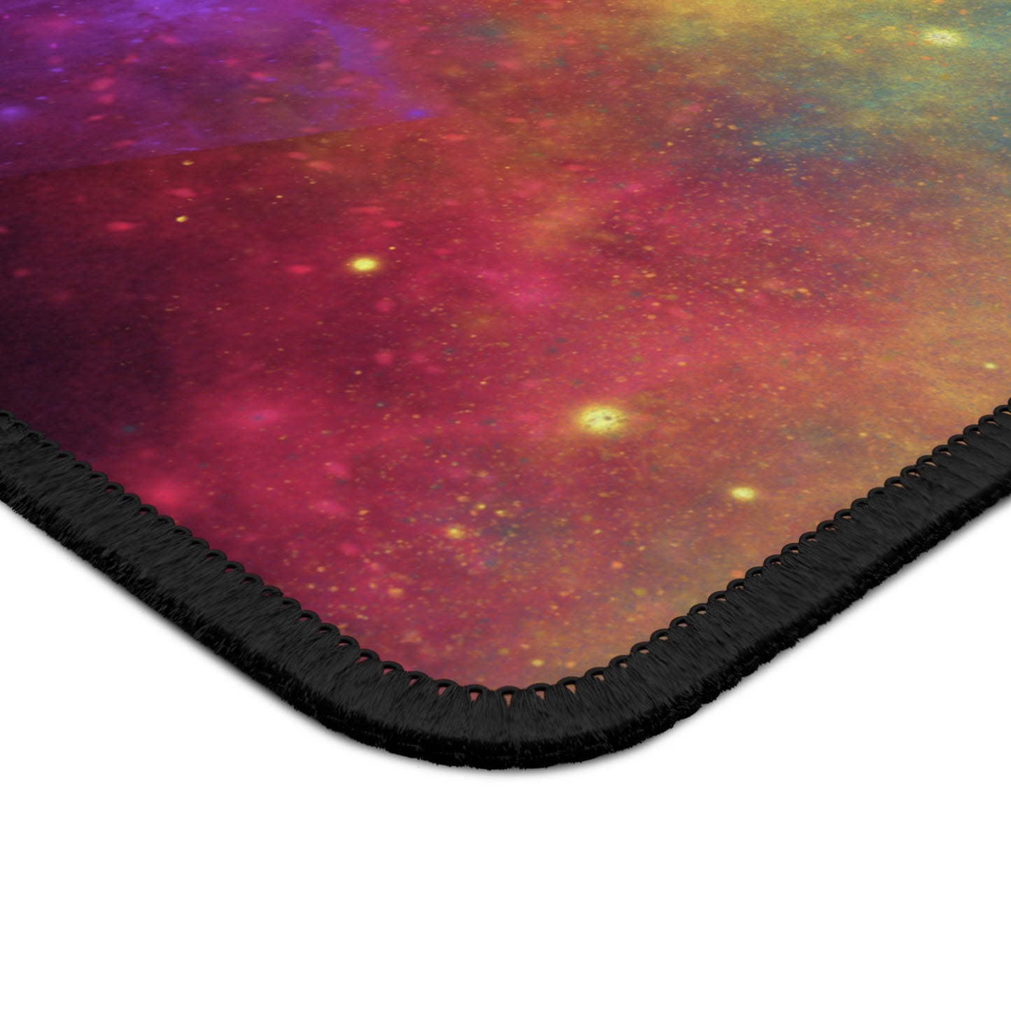 The Printify Cosmic Galaxy Gaming Mouse Pad features a vibrant space design with pink, orange, and yellow hues, star-like dots, a smooth surface, and black stitched edges—perfect for gamers seeking style and performance.