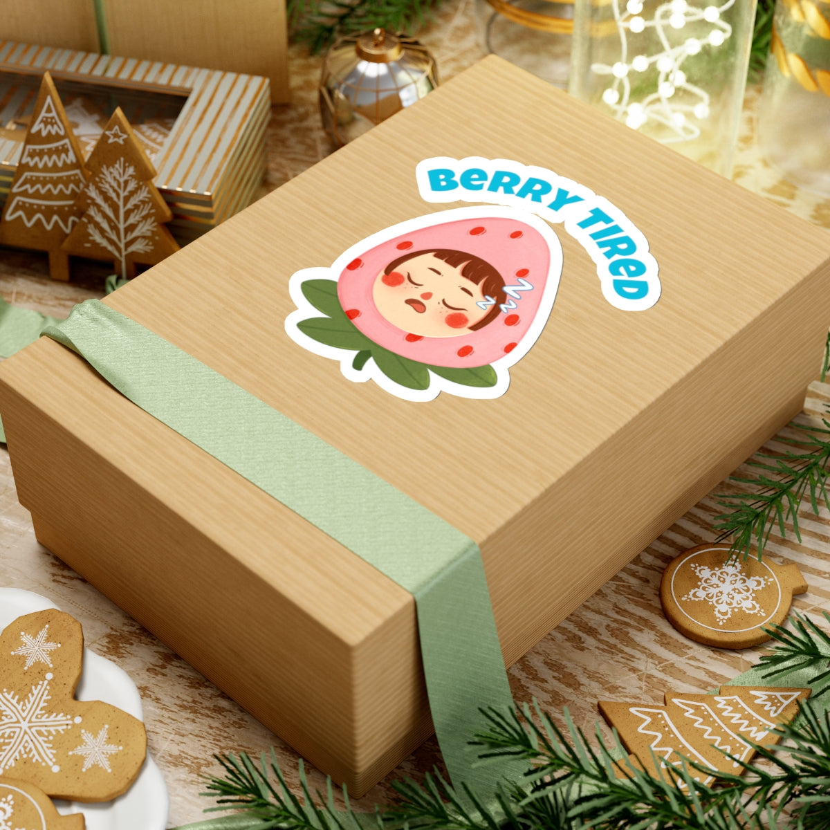 Berry tired vinyl sticker on a gift box with a sleeping strawberry character and festive decorations