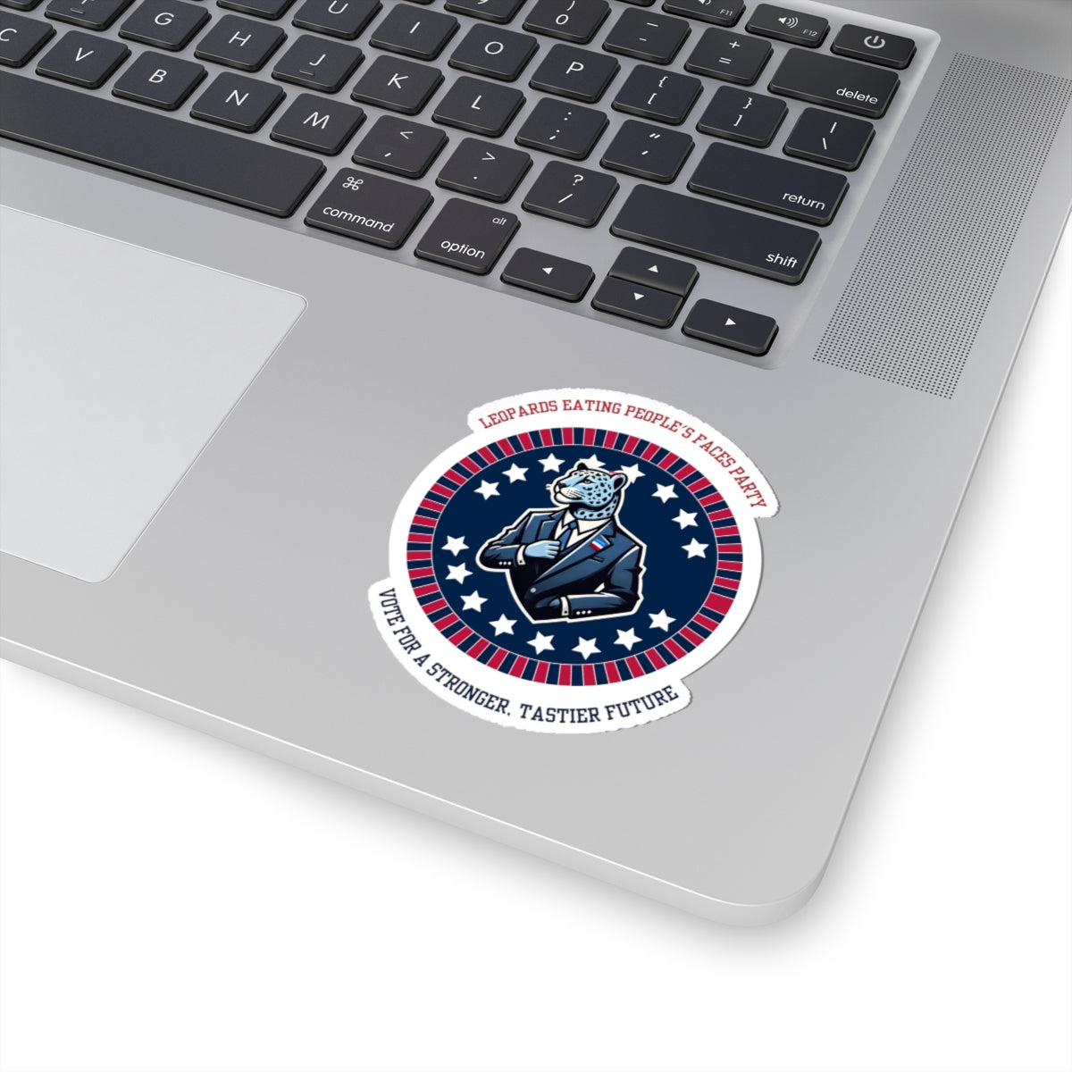 Funny political leopard face eating party sticker on laptop featuring cartoon leopard in suit and patriotic design
