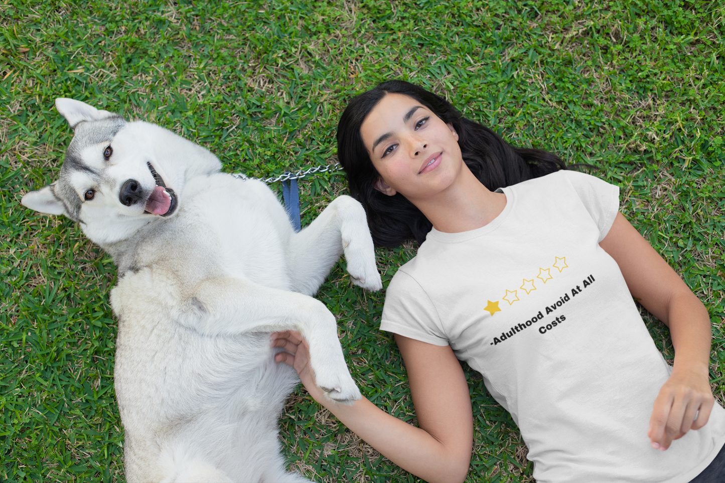 Woman lying on grass with husky wearing Printify t shirt featuring a joke rating design funny adulthood review t shirt