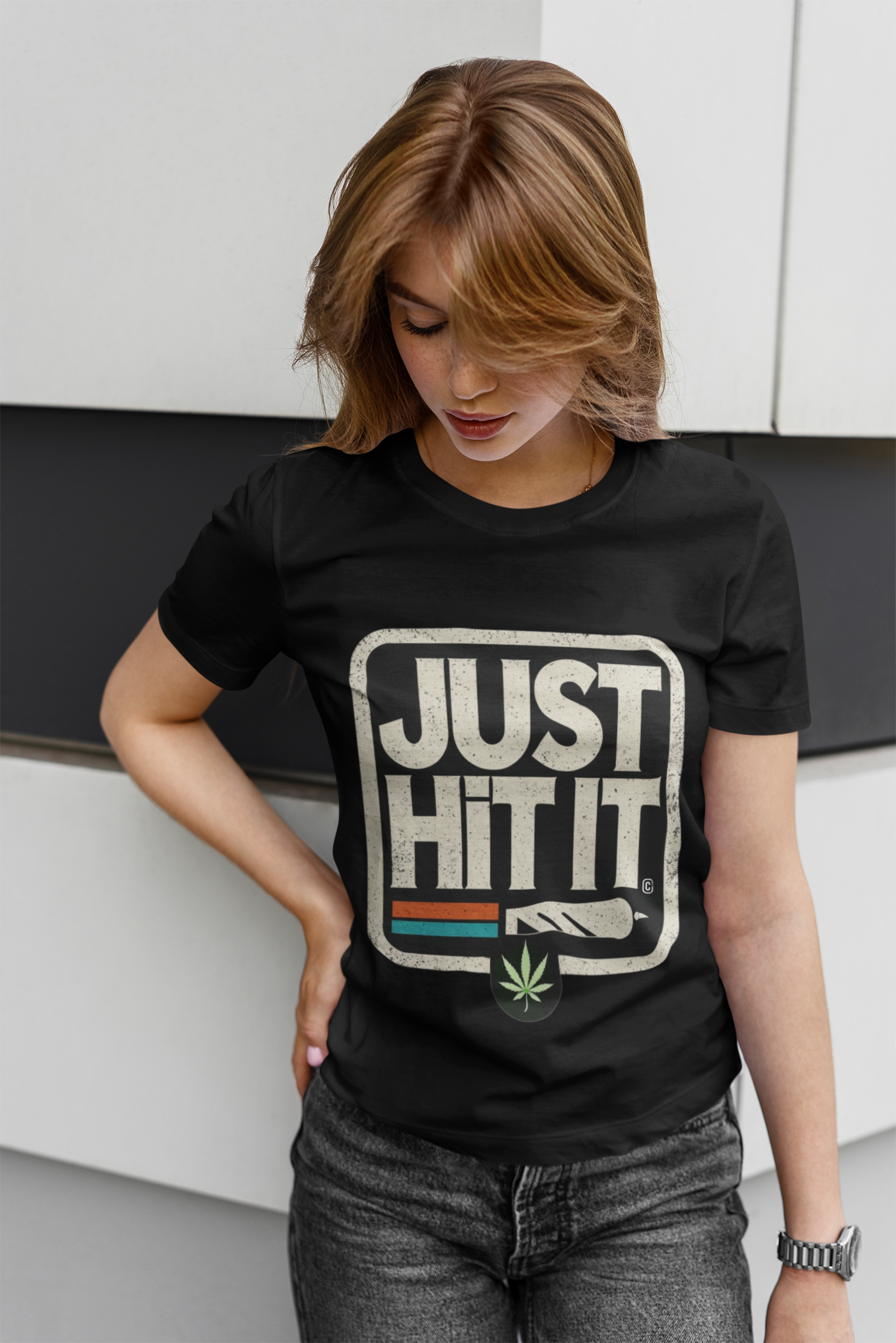 Model wearing Printify black funny weed just do it meme t-shirt with JUST HIT IT joint graphic and cannabis leaf