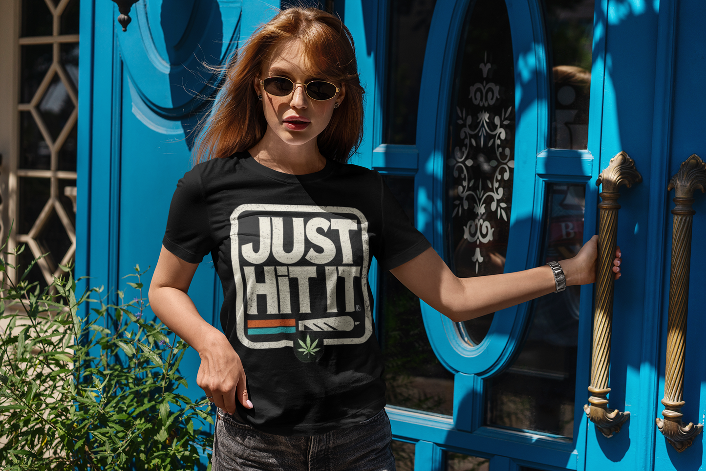 Woman wearing Printify black funny weed just do it meme t-shirt with JUST HIT IT cannabis graphic outdoors