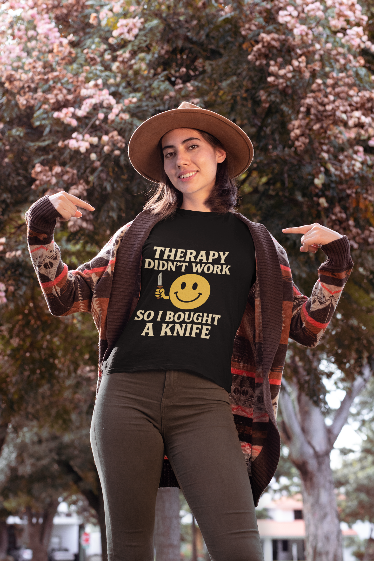 Model in Printify black tee with knife joke print and smiley face therapy dark joke humor unisex t shirt .