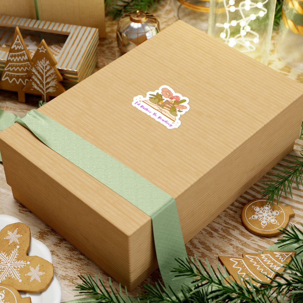 Gift box wrapped with green ribbon featuring an I'd rather be reading cute book lover sticker on top