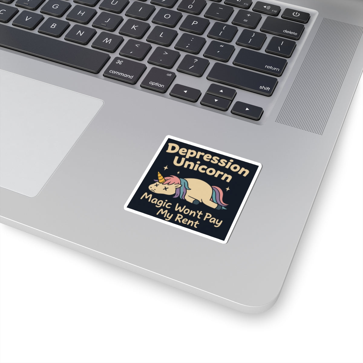 Funny cute unicorn art sticker on laptop showing a sad sleeping unicorn and caption Magic Wont Pay My Rent
