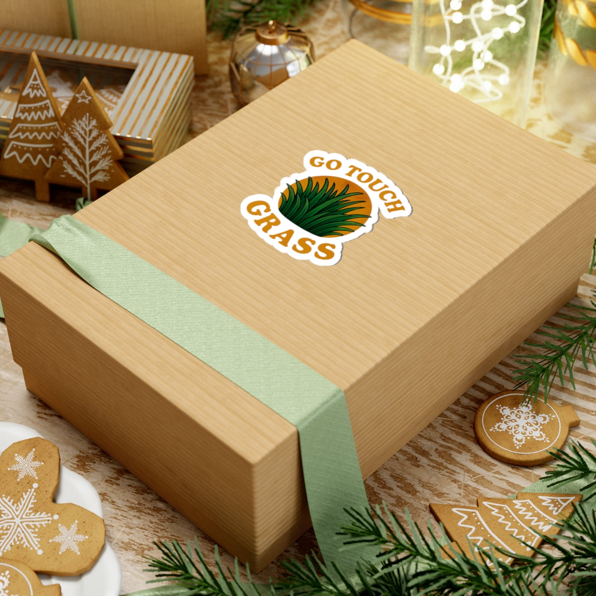 Printify sticker on kraft gift box with mint ribbon showing Go Touch Grass design go touch grass funny meme kiss sticker