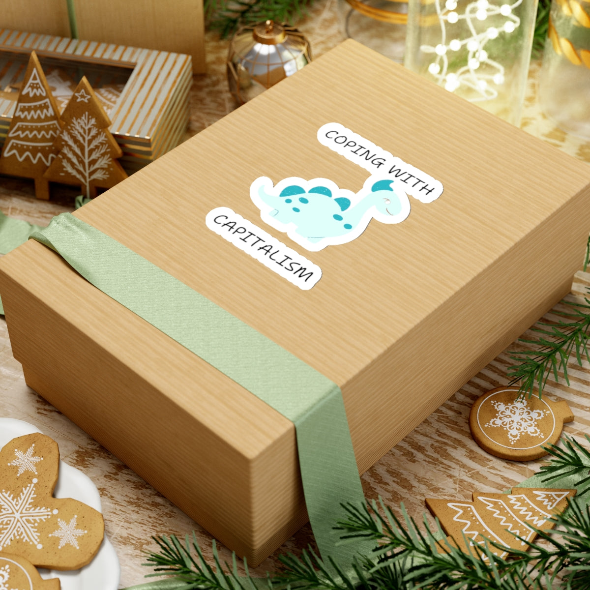Unique sarcastic cute dinosaur sticker with coping with capitalism text on a gift box by Printify