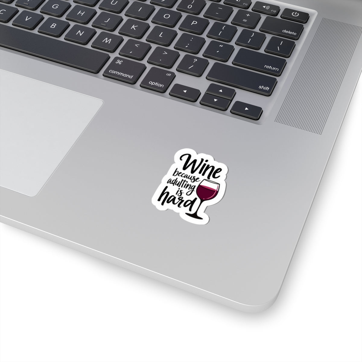 Wine because adulting is hard funny sticker on silver laptop keyboard by Printify