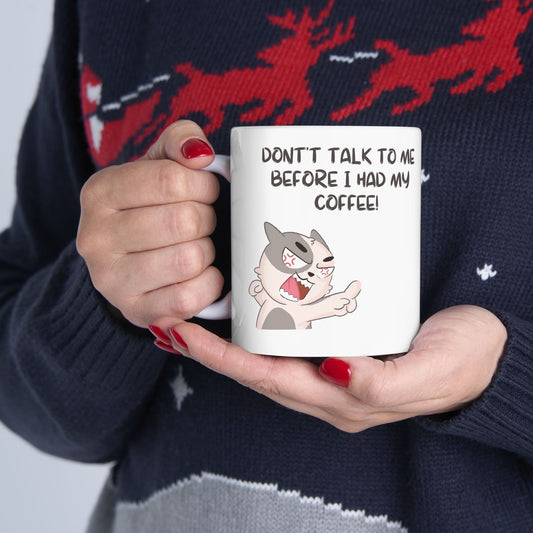 Printify don't talk to me mug with angry cartoon cat and coffee quote held by person in sweater