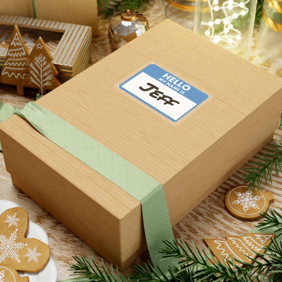 Hello my name is Jeff sticker on gift box surrounded by holiday cookies and decorations