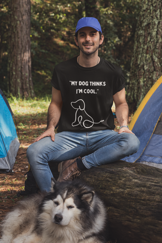 Man camping wearing Printify funny dog lover t shirt black with white dog graphic and husky in foreground